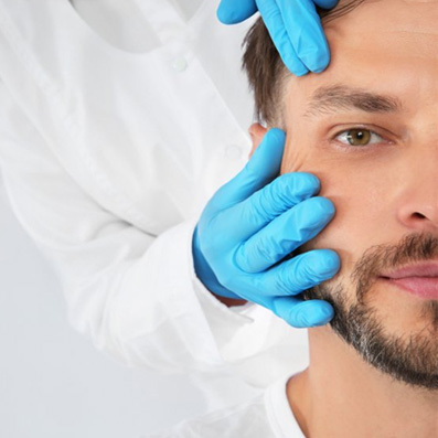 a man smiling while a doctor touches his face
