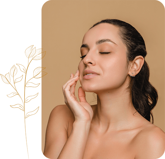 A woman with her hands on her face, reflecting on dental rejuvenation and its impact on her confidence.